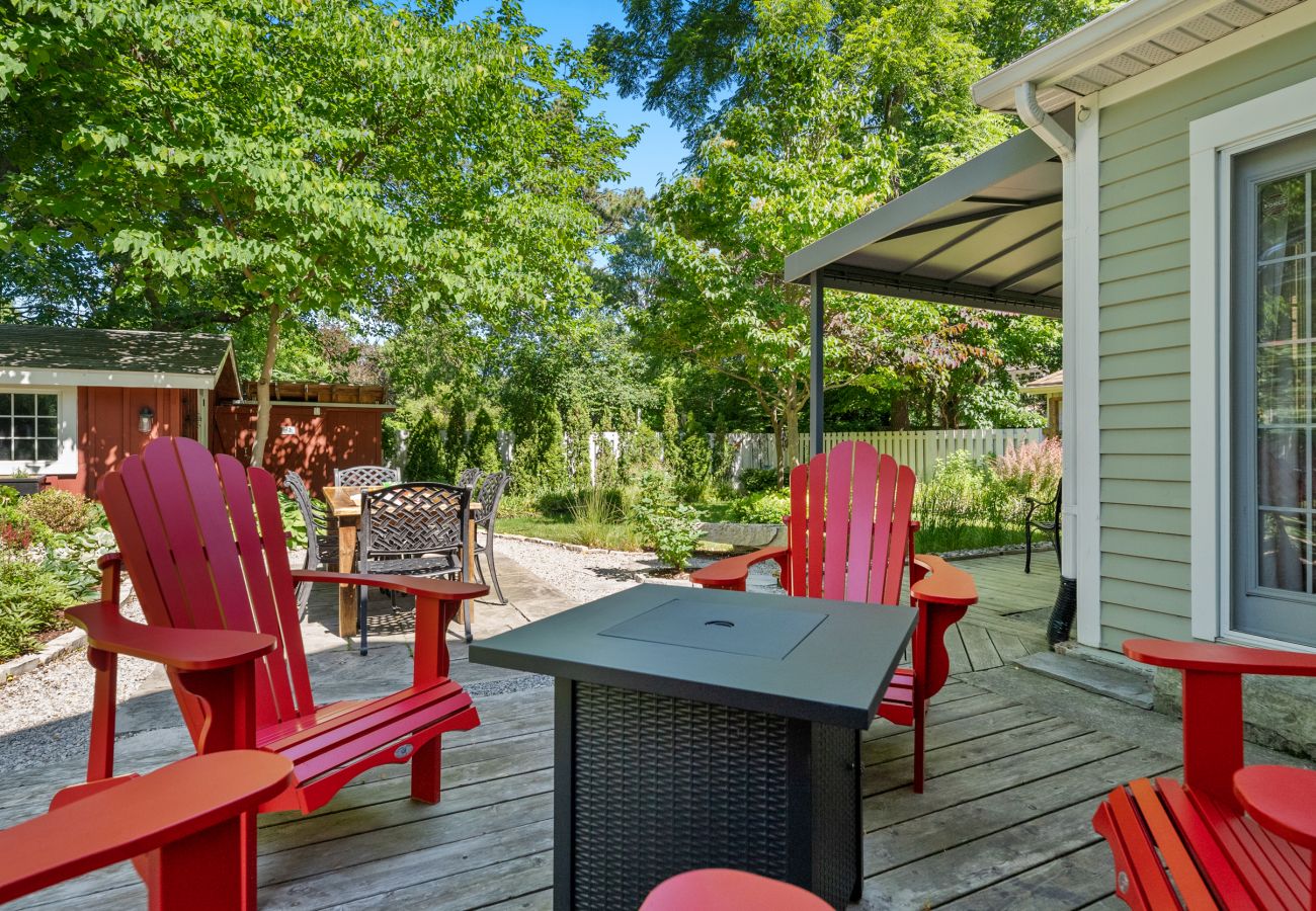 Table and four red Muskoka chairs