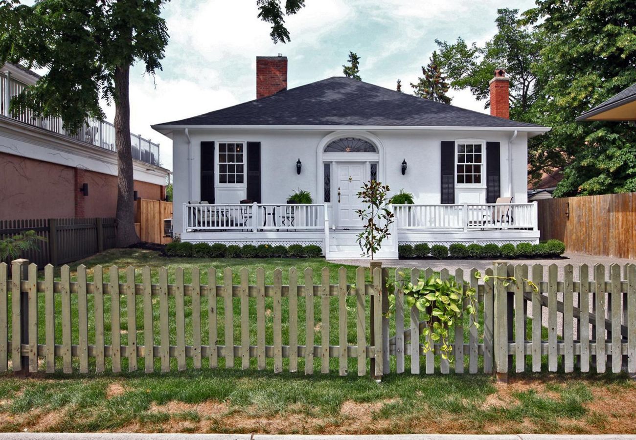 White house with front porch and picket fence